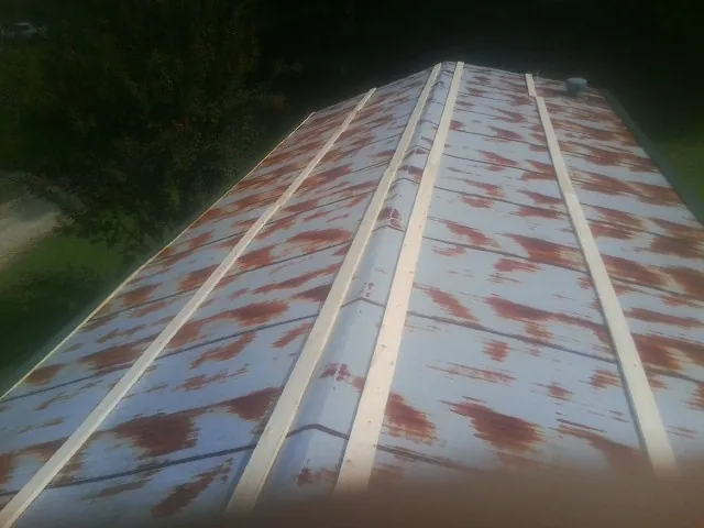 Rusted metal roof panels with new wood purlins before replacement — Storm Damage Roof Repair in Tatums by Roofing Brothers